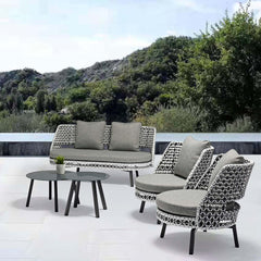 5-piece rattan patio furniture set including rotating armchair and round end table