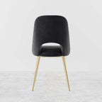 Trendy modern dining chairs in black upholstery with hollow back and elegant gold legs