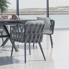 Outdoor dining set with extendable ceramic table and woven aluminum armchairs, 7 pieces