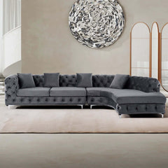 LShaped curved gray sectional sofa upholstered in soft velvet fabric