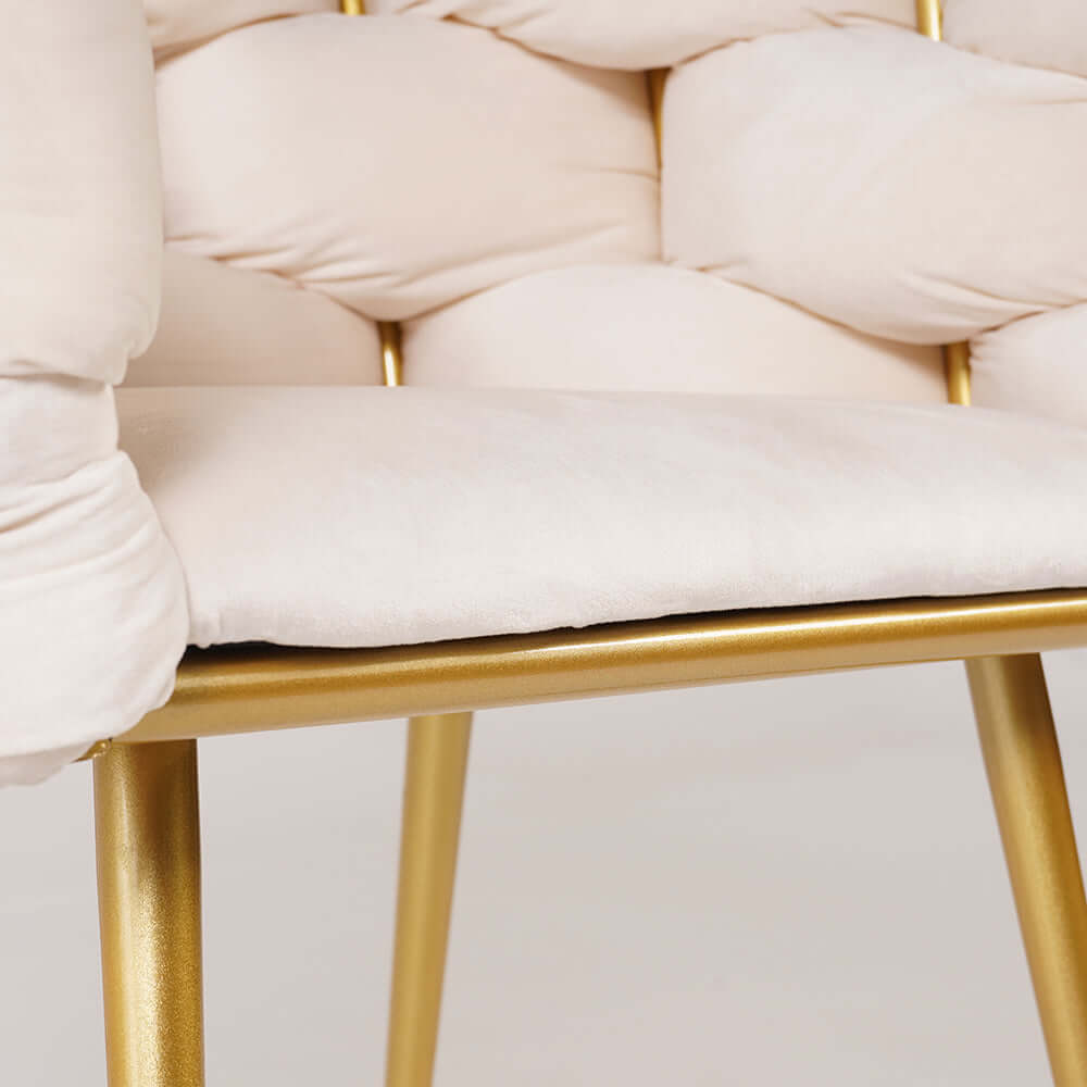 Trendy beige upholstered armchair with elegant gold legs for contemporary interiors