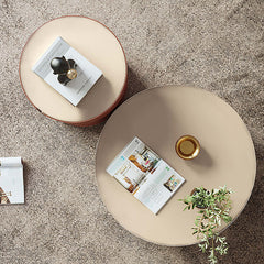 Contemporary round coffee table set in plywood, metal, and saddle leather materials