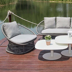 Comfortable Patio Rattan Barrel Chair with White Cushion Pillow for Outdoor Lounging