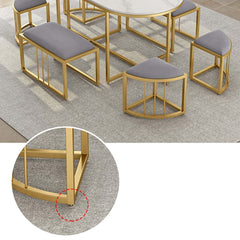 Fashionable oval dining table and stools with sleek white stone top and metal frame for sophisticated dining area