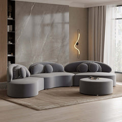 Round sectional beige sofa upholstered in luxurious velvet with ottoman and throw pillows