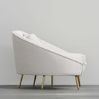 Modern 63 inch pink velvet sofa with curved design, gold metal frame, and matching toss pillow