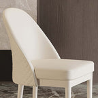 Chic beige faux leather dining chair with minimalist style and strong solid wood base