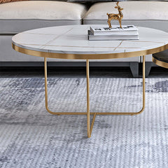 Elegant nesting tables with black and white stone tops and gold bases for luxurious home interior design