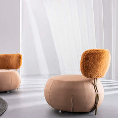 Elegant round chair featuring light brown Boucle Sherpa & LeathAire upholstery