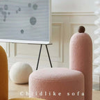 White and pink tripod accent chairs with wood legs and boucle sherpa upholstery