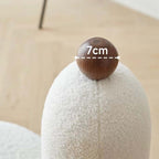 White and pink tripod accent chairs with wood legs and boucle sherpa upholstery