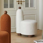 White and pink tripod accent chairs with wood legs and boucle sherpa upholstery