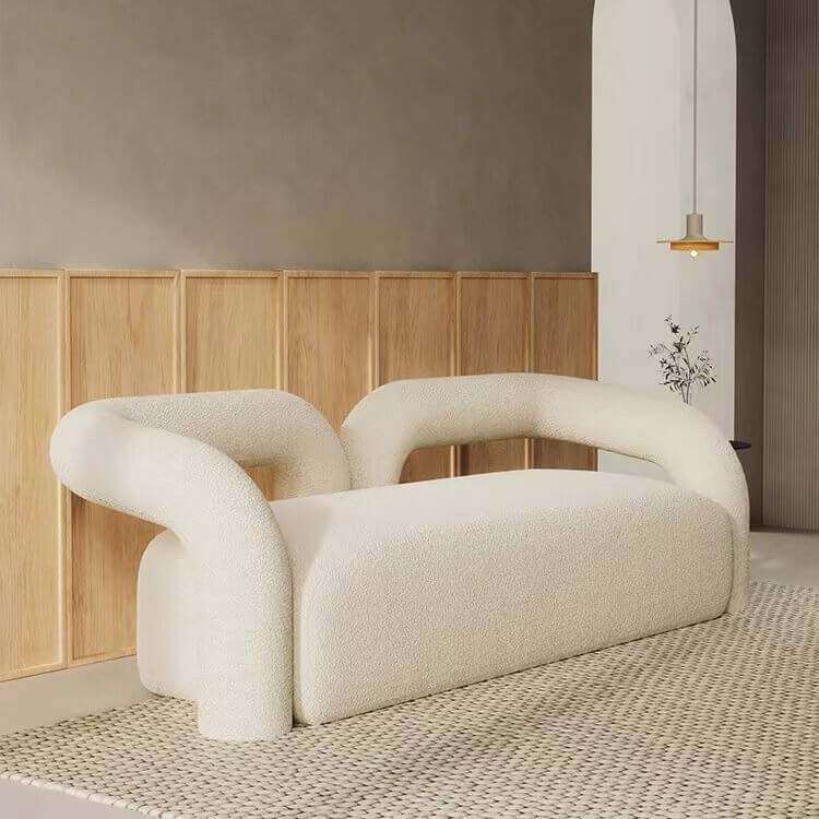 Modern curved sofa upholstered in boucle sherpa fabric with white, gray, yellow, pink, and Tiffany blue colors