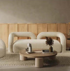 Modern curved sofa upholstered in boucle sherpa fabric with white, gray, yellow, pink, and Tiffany blue colors