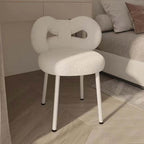 Boucle vanity stool with butterfly-shaped backrest in pink, green, and white colors