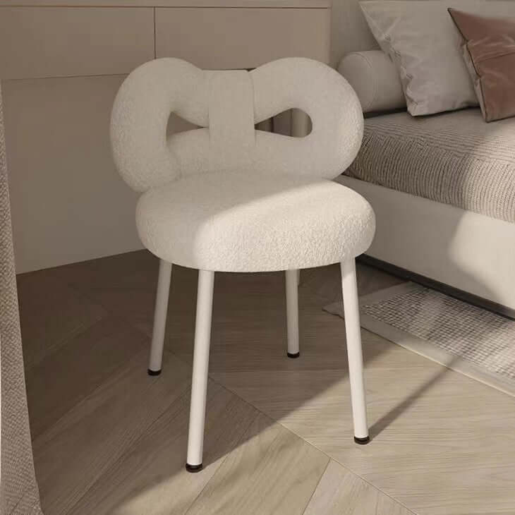 Boucle vanity stool with butterfly-shaped backrest in pink, green, and white colors