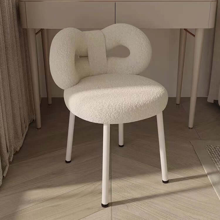 Boucle vanity stool with butterfly-shaped backrest in pink, green, and white colors