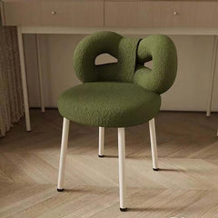 Luxurious pink, green, and white boucle vanity stool accented with butterfly-shaped backrest