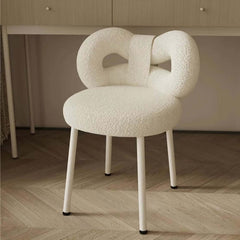 Modern pink, green, and white boucle vanity stool showcasing butterfly-shaped backrest