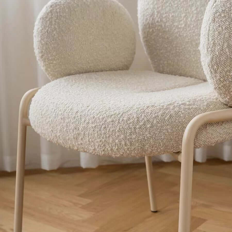 Ivory white boucle accent chair featuring stylish white metal legs for modern living spaces