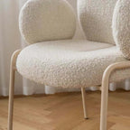 Ivory white boucle accent chair featuring stylish white metal legs for modern living spaces