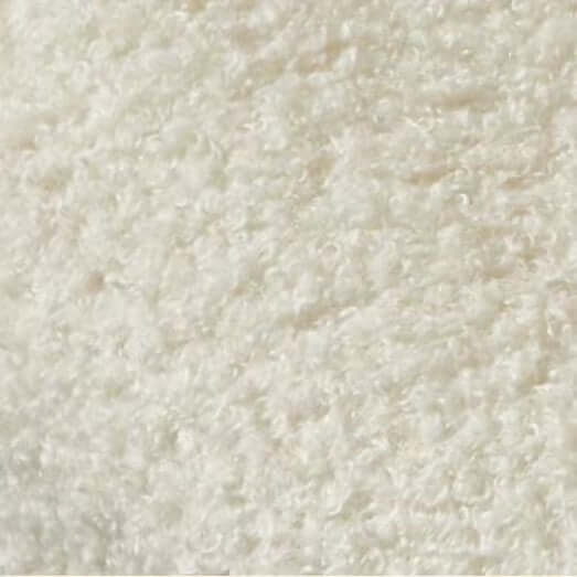 Boucle accent chair in yellow, pink, and white with a unique bear-shaped backrest