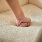 Boucle accent chair in yellow, pink, and white with a unique bear-shaped backrest