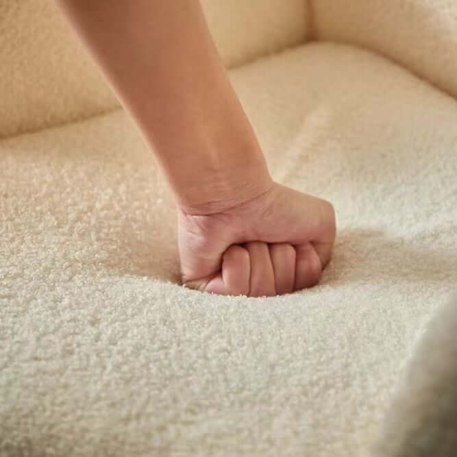 Boucle accent chair in yellow, pink, and white with a unique bear-shaped backrest