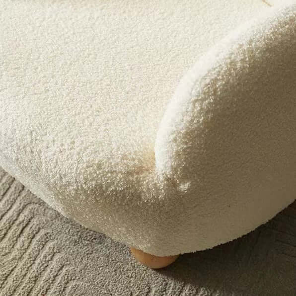 Boucle accent chair in yellow, pink, and white with a unique bear-shaped backrest