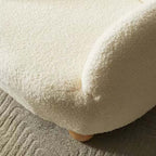 Boucle accent chair in yellow, pink, and white with a unique bear-shaped backrest