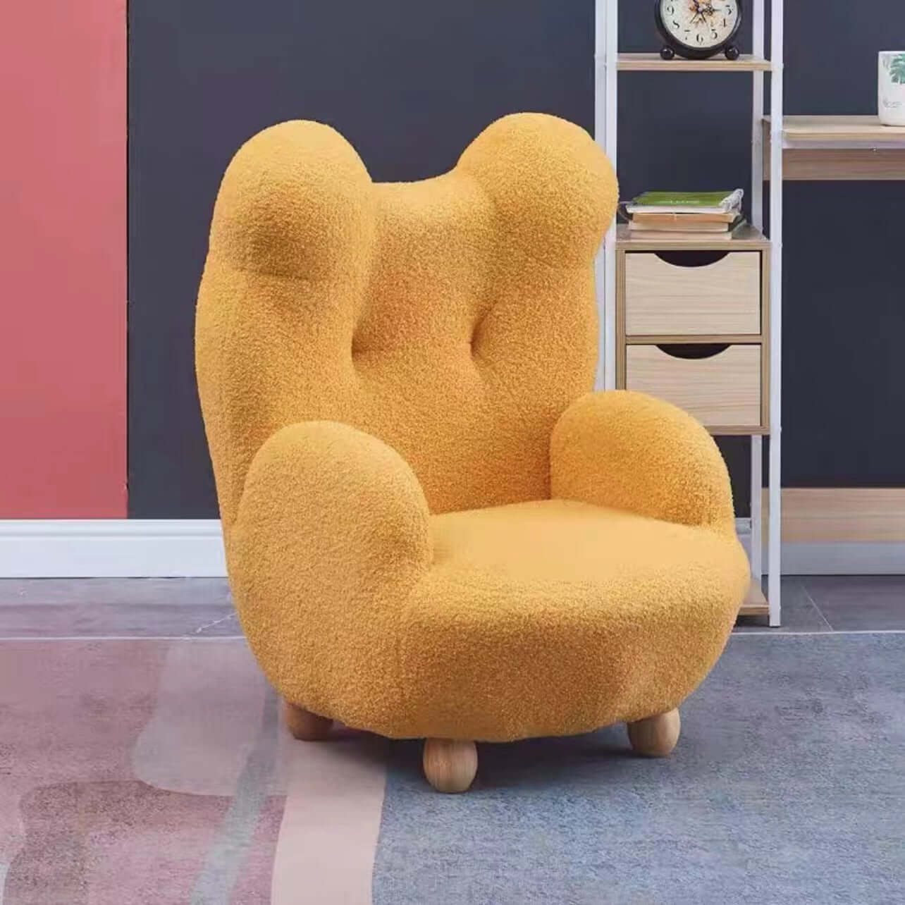 Boucle accent chair in yellow, pink, and white with a unique bear-shaped backrest