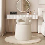 Butterfly-shaped vanity stool in cream-colored boucle fabric with soft texture