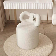 Cream-colored vanity stool with beautifully crafted butterfly shape and boucle fabric