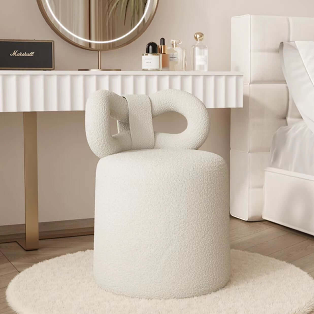 Butterfly-shaped vanity stool in cream-colored boucle fabric with soft texture