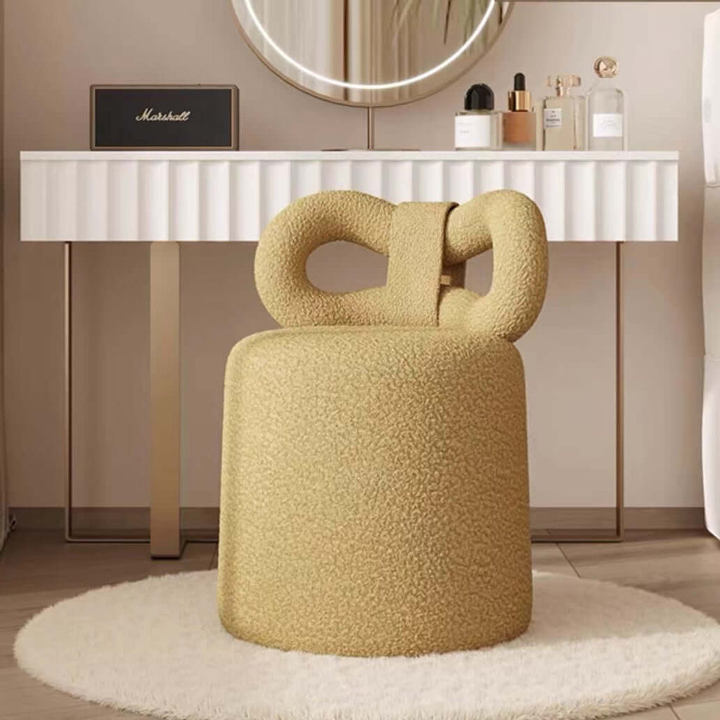 Butterfly-shaped vanity stool in cream-colored boucle fabric with soft texture