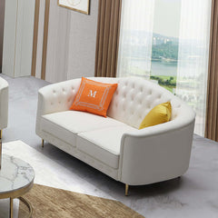 Beige leather sofa and loveseat set with pillows for classy living room decor