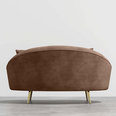 Modern 63 inch pink velvet sofa with curved design, gold metal frame, and matching toss pillow