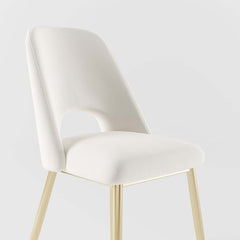 Sleek modern upholstered dining chairs in black with hollow back and shiny gold legs