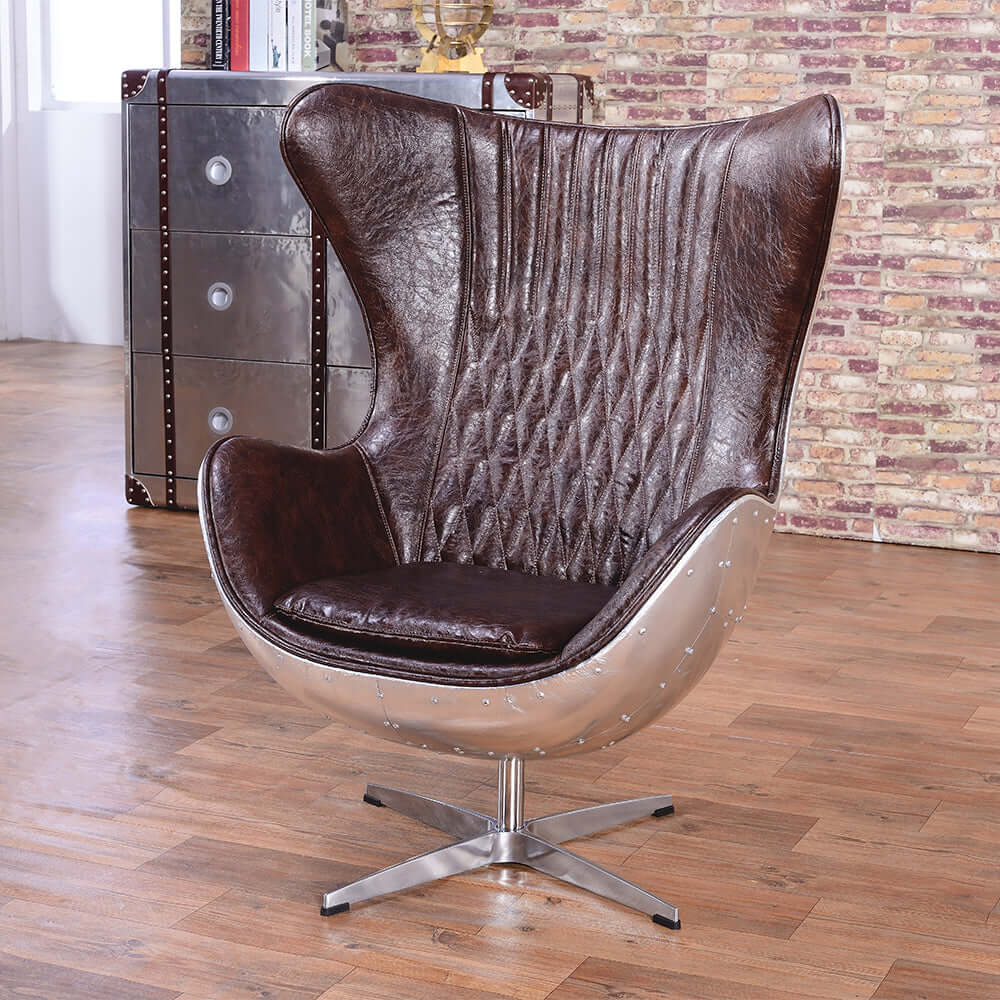 Elegant brown & silver office chair upholstered in luxurious leather with swivel and wing back features
