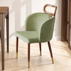 Modern green velvet dining chair with curved back design for comfortable seating