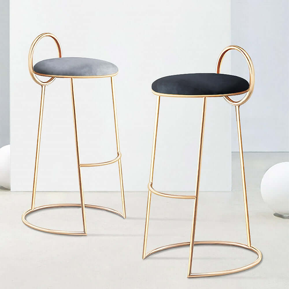 Contemporary gray velvet bar stool with low backrest and elegant gold legs for home decor
