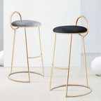Contemporary gray velvet bar stool with low backrest and elegant gold legs for home decor