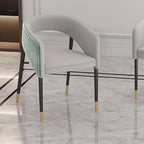 Green velvet upholstered dining chair with modern design and metal accents