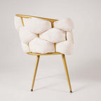 Chic beige upholstered armchair with modern gold legs for stylish living spaces