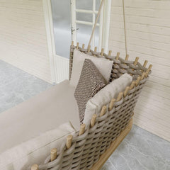 Woven Rattan Sofa Swing with Shiny Khaki Cushion Pillow for Relaxing Outdoor Porch Time