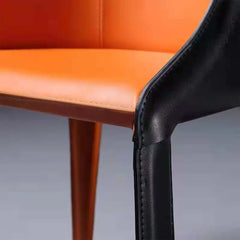 Stylish black and orange leather dining chair with metal legs for modern interior design