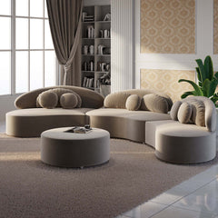 Contemporary 7-seat beige velvet upholstered sofa with round sectional design, ottoman, and pillows