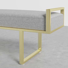 Stylish gray linen upholstered bench with gold legs, a luxurious addition to modern bedroom and entryway