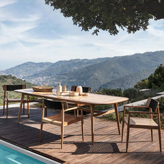 7 piece modern outdoor dining set with teak wood table and chair in natural setting