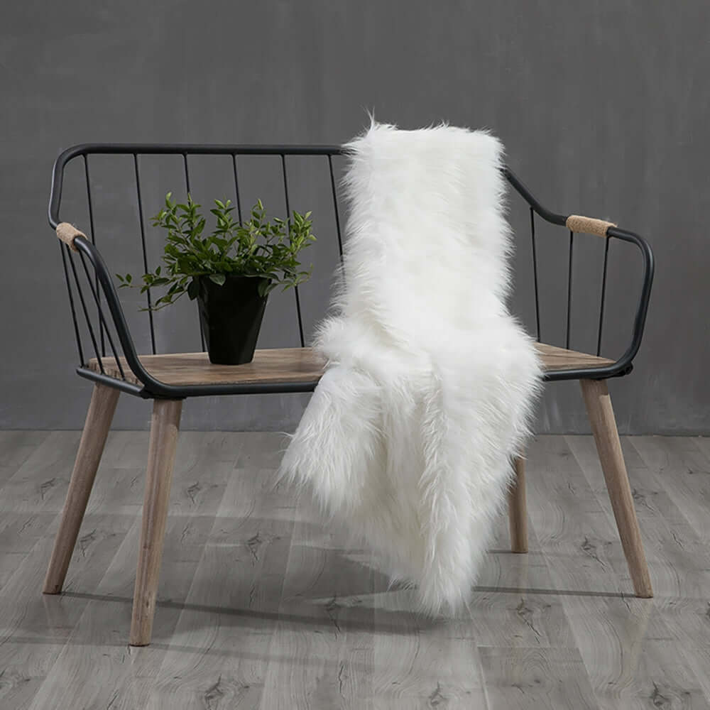 Rustic wooden bench with comfortable backrest and armrests for outdoor seating